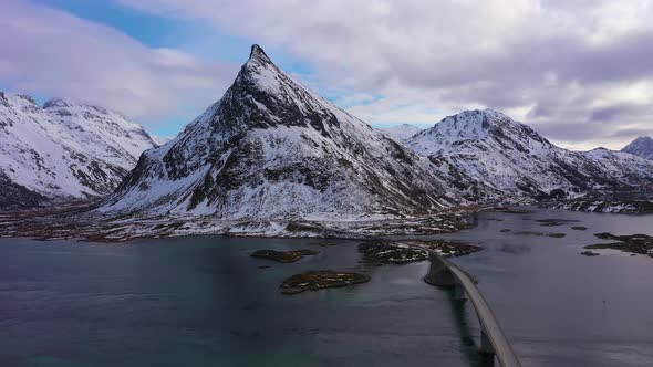 Fredvang Bridge and Volandstind Mountain in Winter. Lofoten, Norway. Aerial View