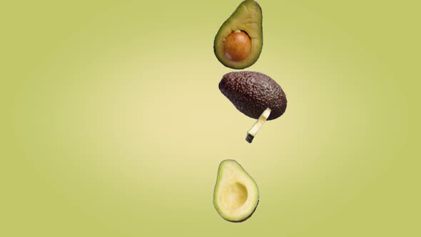 Avocado Halves and Slices That Fall on a Yellow Green Background