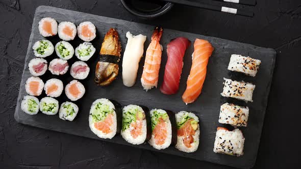 Sushi Rolls Set with Salmon and Tuna Fish Served on Black Stone Board