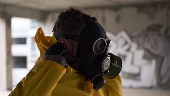 Post Apocalypse Man in Abandoned Building Takes Off His Gas Mask and Breathes Deeply Breathing