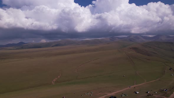 Endless Green Fields with Mountains and Big Clouds