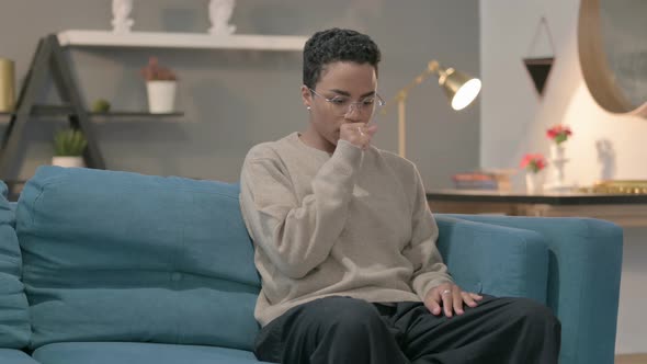 African Woman Coughing While Sitting on Sofa