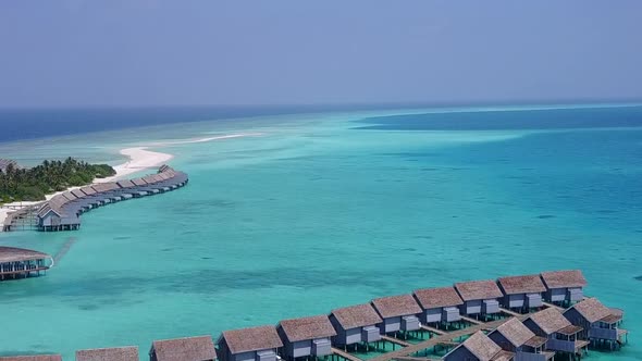 Aerial travel of coast beach break by blue water with sand background