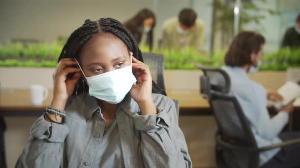 A Beautiful Lady is Putting a Protective Mask on Her Face