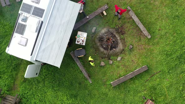 RV Park Pitch with Camper Van and Campfire