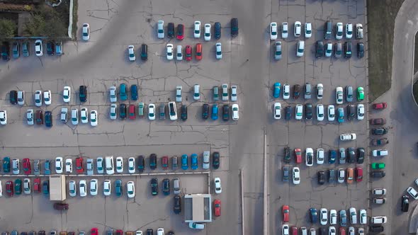 Aerial Shot, Lots of Cars Downstairs. Parking of a Shopping or Business Center. A Lot of Occupied