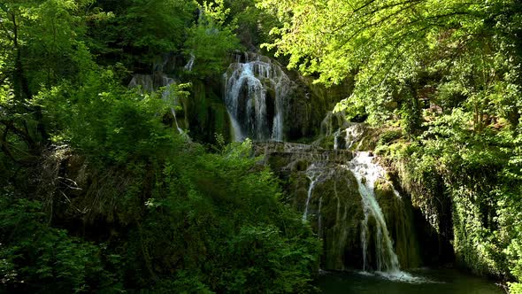 Video with a beautiful waterfall in green spring forest