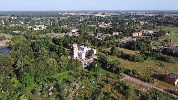 Vecauce Manor in Latvia Aerial View of the Pink Castle Through the Park. Vecauce Castle Tower With a