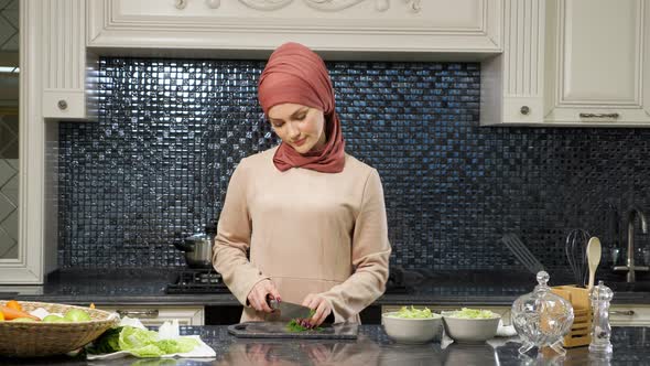 Oriental Woman Cooks Meal Cutting Fresh Greens Smiling