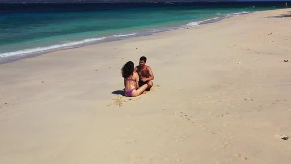 Man and lady sunbathing on tranquil sea view beach journey by clear ocean and clean sand background 