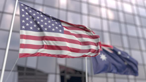 Waving Flags of the USA and Australia in Front of a Skyscraper
