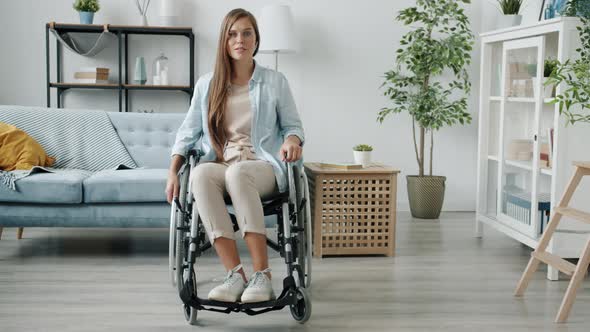 Slow Motion Portrait of Beautiful Paraplegic Lady Sitting in Wheelchair in Modern Room