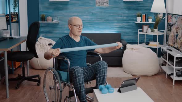 Old Person with Disability Pulling Resistance Band to Stretch