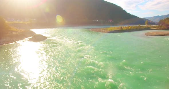 Low Altitude Flight Over Fresh Fast Mountain River with Rocks at Sunny Summer Morning