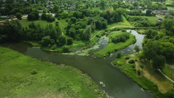 Flight Over The City Park. You Can See The Lilies On The River. Aerial Photography From Above