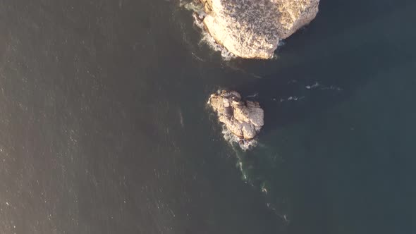 Aerial footage featuring high sea cliff landscape of Cabo de Sao Vicente Lighthouse, Sagres