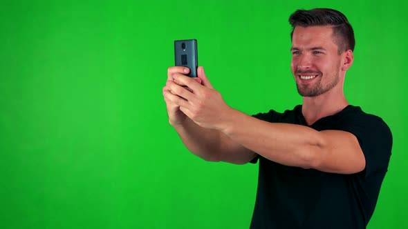 Young Handsome Caucasian Man Photographs with Smartphone (Selfie) - Green Screen