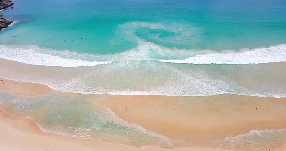 Aerial view beach white sand beach top view, beautiful sea with waves at sunny day. Summer holiday