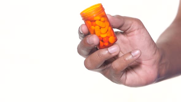 Person Hand Holding Pill Container Isolated on White alt