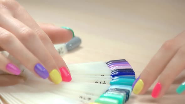 Close Up Hands and Nail Polish Samples.