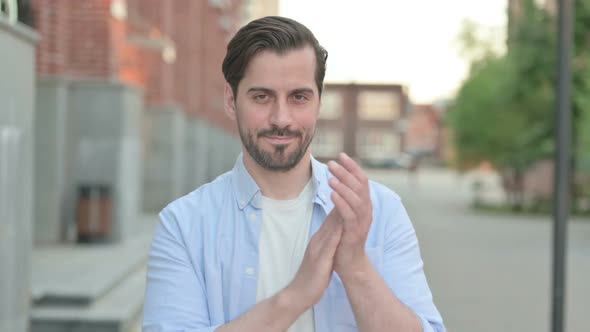 Man Clapping While Standing Outside