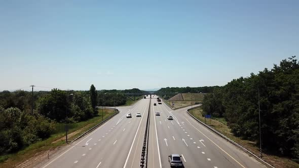 Fly Over Highway Road Junction in the Countryside with Trees and Cultivated Fields.