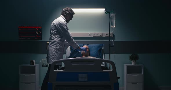 Mature Doctor Stopping Life Support of Dead Patient