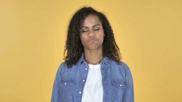 African Girl Shaking Head to Reject Isolated on Yellow Background