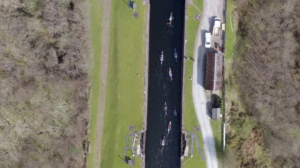 A Large Group of Canoeists Traversing a Canal Lock