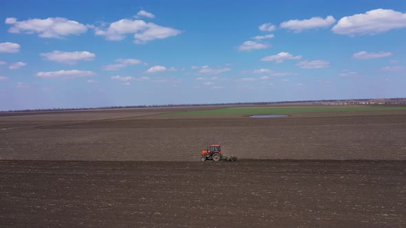 Red Tractor and Plow Aerial Landscape View