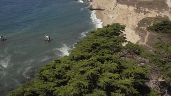 Aerial View of old broken pier made of cement in the middle of the ocean near Santa Cruz California.