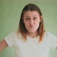 Funny Lady in White Clothes Makes Angry Grimaces on Green - VideoHive Item for Sale
