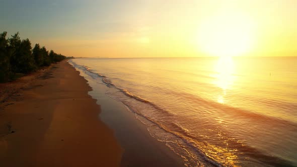 An aerial view of a drone flying over a sandy beach