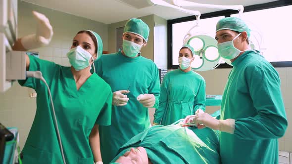 Medical team looking at a monitor