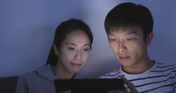 Asian couple use of tablet computer at home