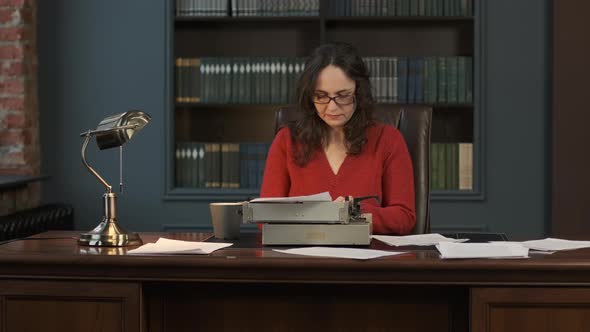 Female Writer Typing on Vintage Writing Machine