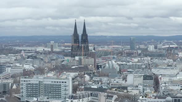 AERIAL: Wide Shot of Cologne Germany From the Air with Majestic Cathedral on Cloudy Day 