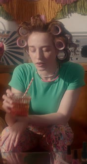 Girl in Curlers Drinking in 80s