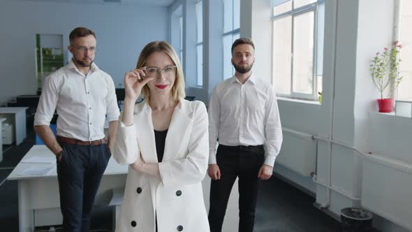 Men and Woman Stand and Look on the Camera