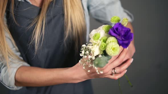 Slowmotion Shot of Hands of Professional Blonde Female Floral Artist Arranging Beautiful Bouquet at