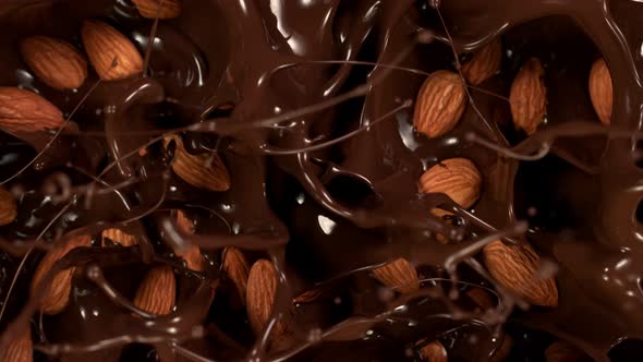 Super Slow Motion Shot of Almonds Falling Into Melted Chocolate at 1000 Fps