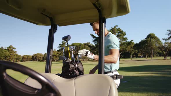 Male golfer removing golf club from golf bag