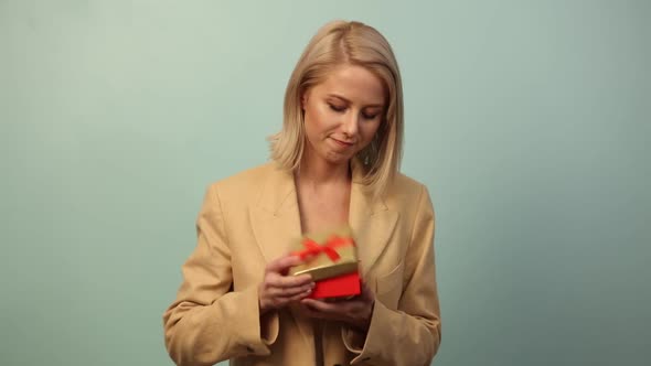 Style woman with gift box on blue background