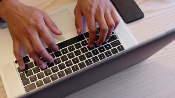 Businessman using laptop in a modern office 4k