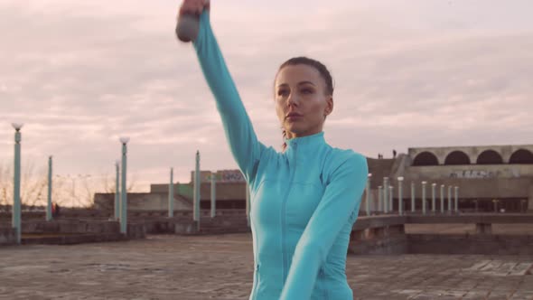 Young, beautiful and sporty woman having evening training outdoor.