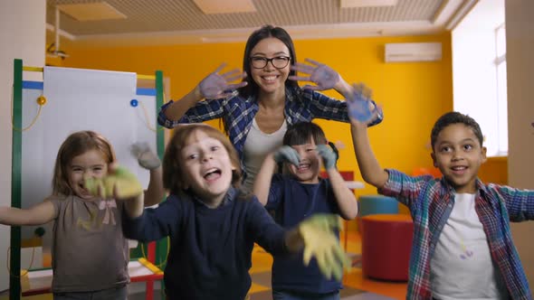 Diverse Kids Showing Hands Painted with Paint