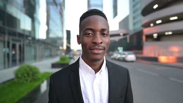 Young black guy on the street against the background of a business center