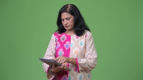 Mature Beautiful Indian Woman Using Digital Tablet