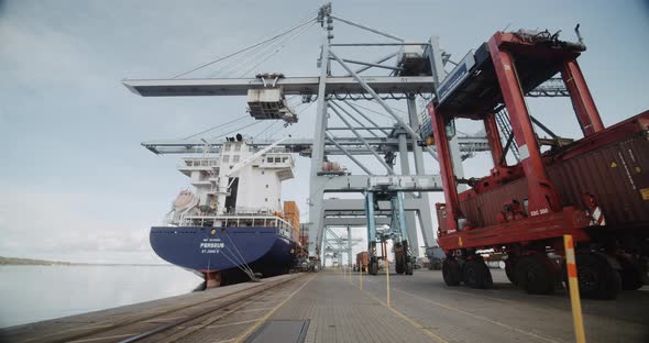 Breathtaking View of Harbour Cranes Moving Container Cargo Against Clear Sky alt