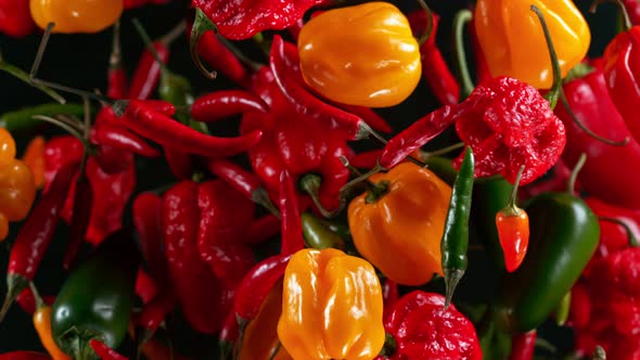 Super Slow Motion Shot of Flying Mixed Chilli Peppers Towards Camera at 1000Fps